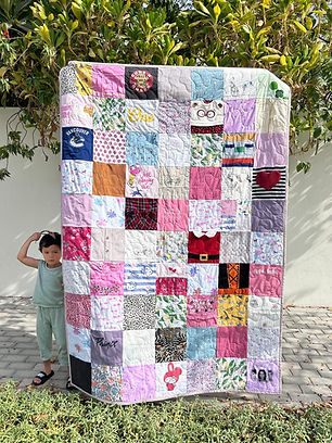 A quilt made from adult branded T-shirts